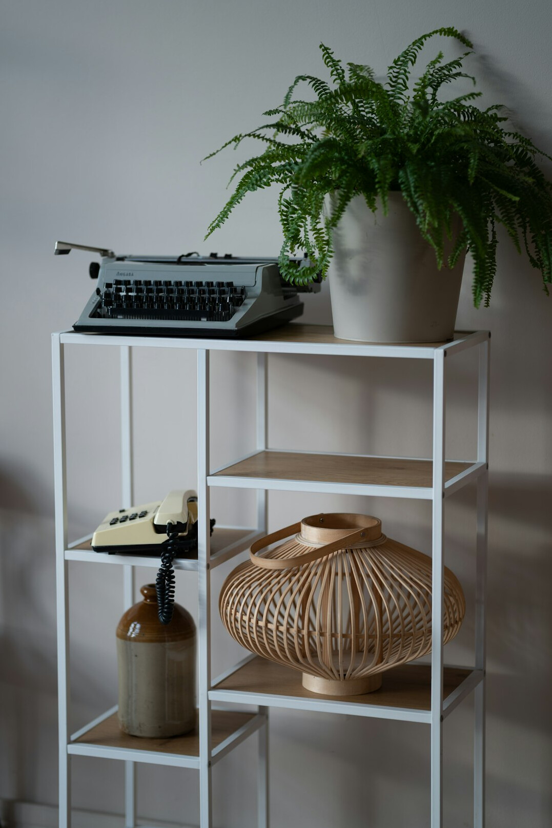 Home office desk with a typewriter, lamp and bookshelf in vintage style
